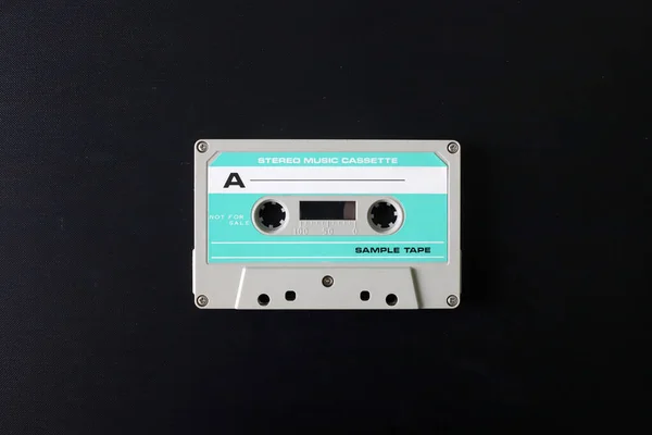 Old tape cassette, old or aged wood background. solated casette