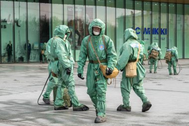 Medical workers in bio viral hazard protective suits disinfects street from coronavirus COVID-19. Antibacterial sanitary measures on quarantine. clipart