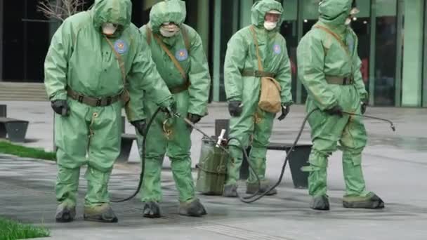 NURSULTAN, ALMATY, KAZAKHSTAN, MARCH 25, 2020: People in bio viral hazard protective suits. Disinfection and decontamination on a public place as a prevention against Coronavirus disease, COVID-19. — Stock Video