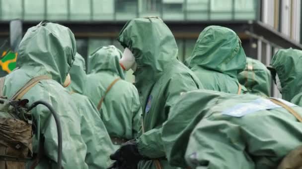 NURSULTAN, ALMATY, KAZAKHSTAN, MARCH 25, 2020: People in bio viral hazard protective suits. Disinfection and decontamination on a public place as a prevention against Coronavirus disease, COVID-19. — Stock Video