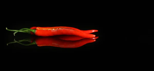 Black background with red hot pepper and reflection — Stock Photo, Image