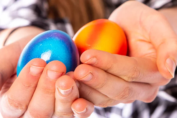colored eggs with hands tapping and crushing eggs with copy space