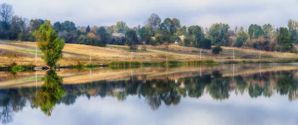 Reflectie. Aan de oever van de rivier in de herfst — Stockfoto