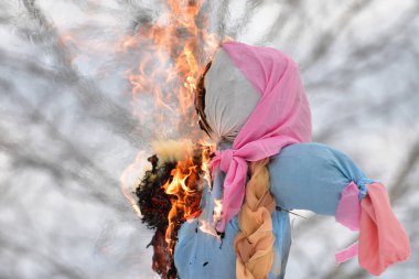 Shrovetide in Russia, burning a scarecrow on the day of winter farewell clipart