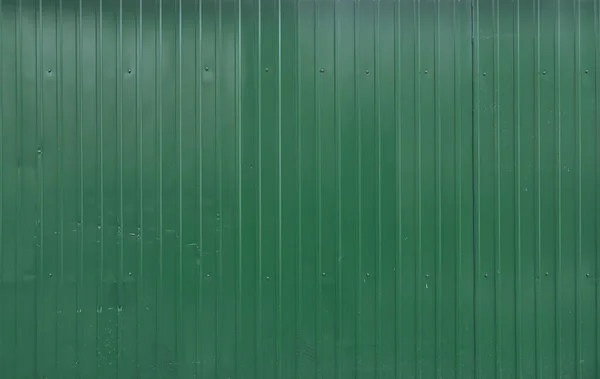 Green metal decking. Sheets of green corrugated iron