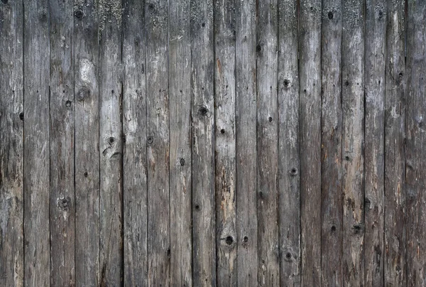 Tábuas velhas, uma parede de madeira descascada de cor marrom — Fotografia de Stock