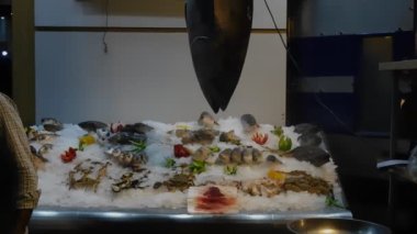 Deniz ürünleri tezgahları ve yürüyen insanlarla dolu akşam caddesi, Sharm El Sheikh, Mısır.