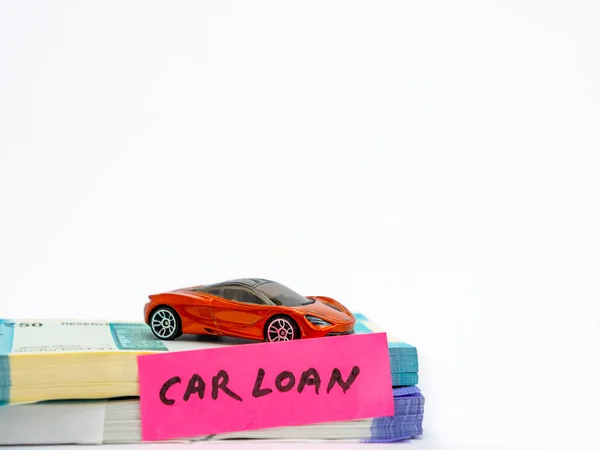 A small toy car with money bundles in loan concept.