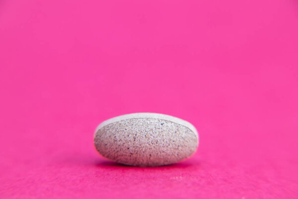 pill isolated on pink with clipping path. Medicine and pharmacy concept