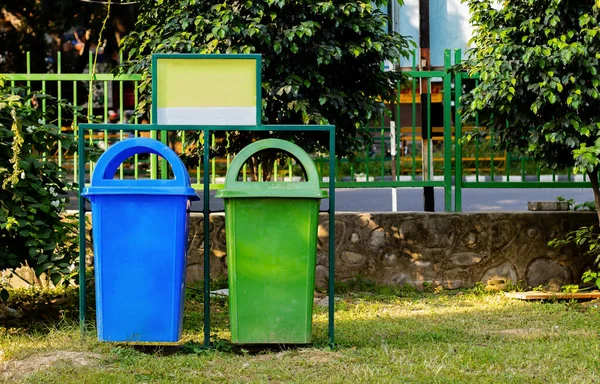 paper and plastic recycle bin placed in the garden for cleanness. cleanness concept