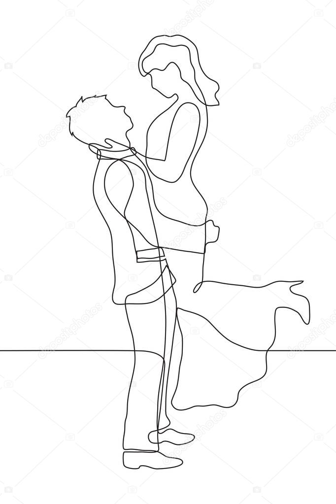 Lovers man and woman look at each other. The guy holds the girl in his arms, clutching to himself, her hands on his shoulders. The girl is wearing a long dress and high heel shoes, her hair is loose. 