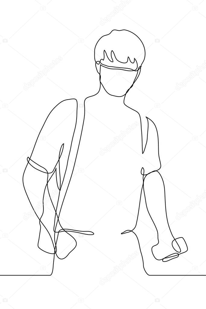 One continuous line art silhouette of a young man in a medical protective mask for protection against coronavirus in a T-shirt with a backpack on his back, a hand in his pocket, a second hand phone
