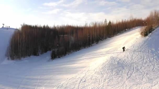 Snowboarder paseos en una ladera de una montaña en un día de invierno, vista superior — Vídeos de Stock