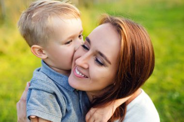 Birlikte hayatın tadını çıkarıyoruz. Mutlu anne ve oğul güneşli bir yaz gününde dışarıda eğleniyorlar. Anne ve oğul birlikte eğleniyorlar. Anneler Günü.