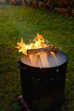 Sonbaharda bahçenin ortasında yanan fıçı.