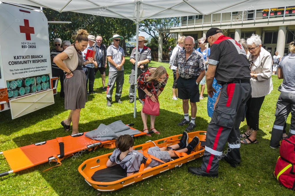 A Red Cross emergency response team demonstrating their equipment. The child in the foreground is lying in a basket stretcher. Tauranga, New Zealand, November 23 2019