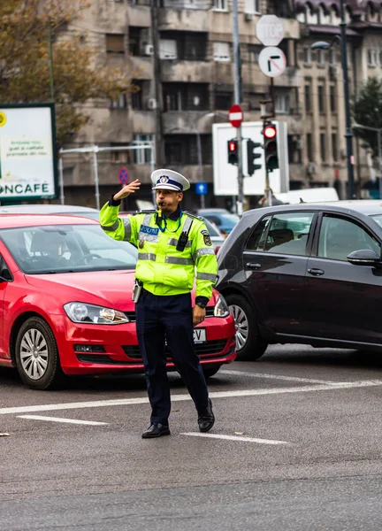 Polisagent som leder trafiken under morgonrusningen i d — Stockfoto