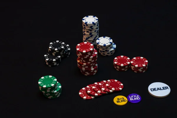 Stack of poker chips on black background, poker chips spread, bi — Stock Photo, Image