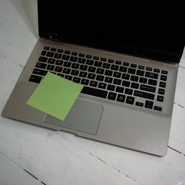 Colorful sticky note on laptop keyboard. Post it on keyboard.