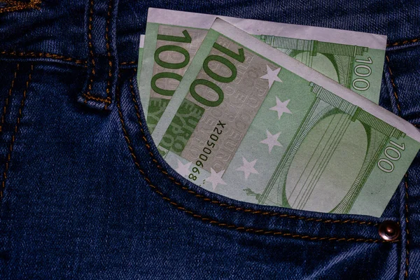 Banknotes, money in a jeans pocket, close up. Money stick out of — Stock Photo, Image