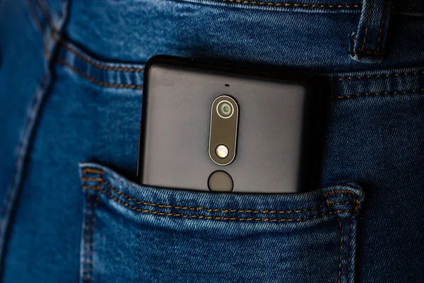 Close up smartphone in jeans back pocket. Business and fashion c — Stock Photo, Image