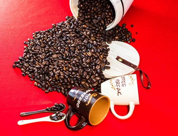 Чашка кофе, деревянная банка кофе и жареные кофейные зерна в s — стоковое фото
