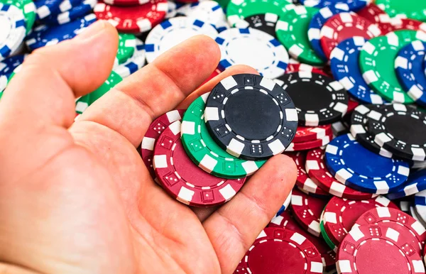Hand holding and giving poker chips poker chips background. Casi — Stok fotoğraf
