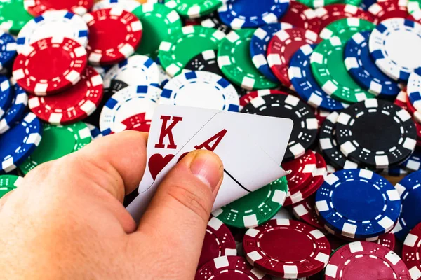 Poker hand over poker chips background. Casino concept for busin