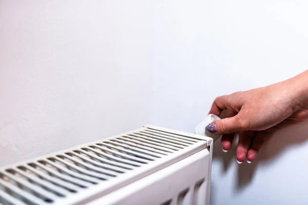 Close up of hand adjusting heating thermostat. Central heating c — Stock Photo, Image