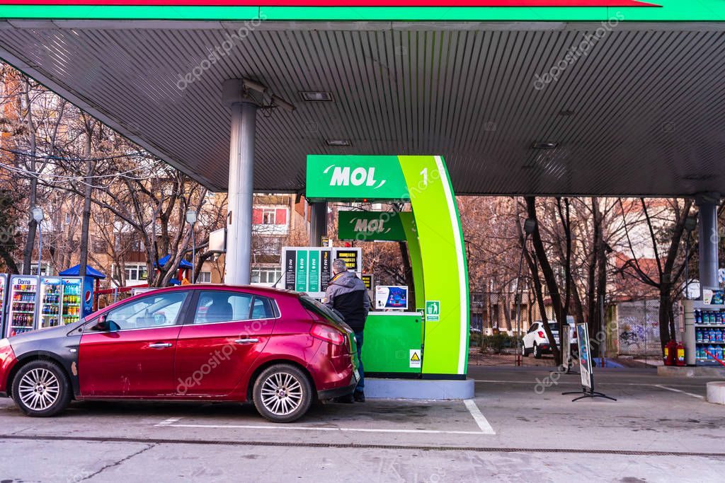 People filling their car tanks at MOL petrol gasoline station in Bucharest, Romania, 2020