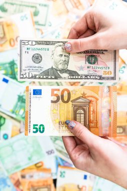 El ele tutuşan para, banknotların arkasında izole edilmiş. Euro ve Biz
