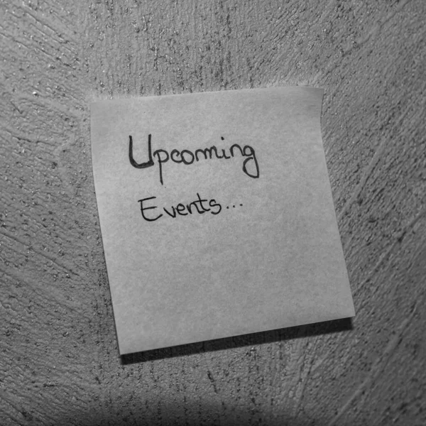 Text Upcoming events on post it. Writing on sticky note. Buchare