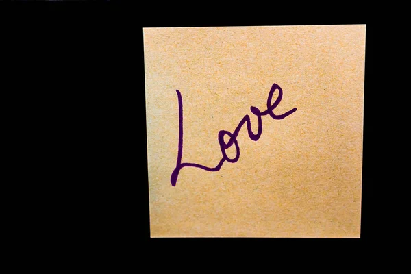 Text Love on post it, isolated on black background. Writing on s — 스톡 사진