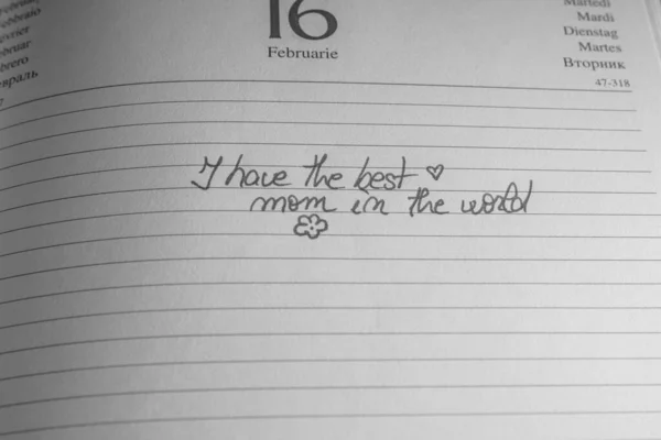 Mother`s day concept. Writing text for mother on personal agenda