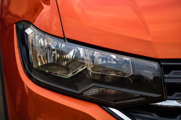 Close up photo of modern and clean car, detail of headlight. Hea