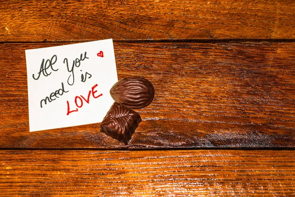 Schokoladenbonbon, Praline auf Memo Post Reminder mit Liebestext. — Stockfoto