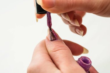 Manikür yapan kadın elleri, altın renginde oje.