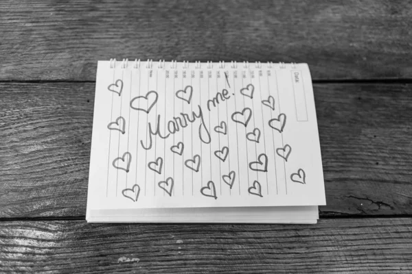 Marry me, writing love text on paper, lovely message. Text on sp — Stockfoto