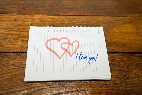 I love you, writing love text on paper, lovely message. Text on