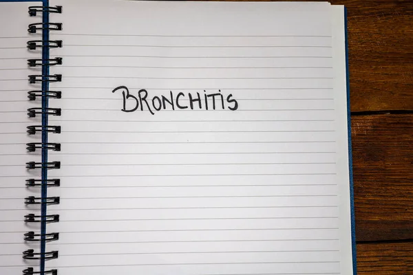 Bronchitis handwriting  text on paper, on office agenda. Copy sp — 图库照片