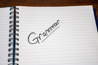 Grammar handwriting  text on paper, on office agenda. Copy space