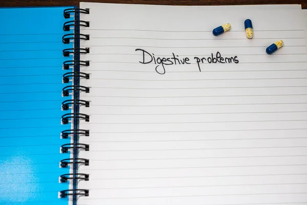 Digestive problems handwriting  text on paper, on office agenda. — 图库照片