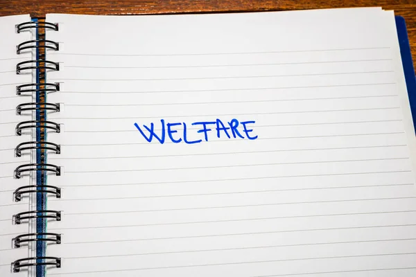 Welfare handwriting  text on paper, on office agenda. Copy space — ストック写真