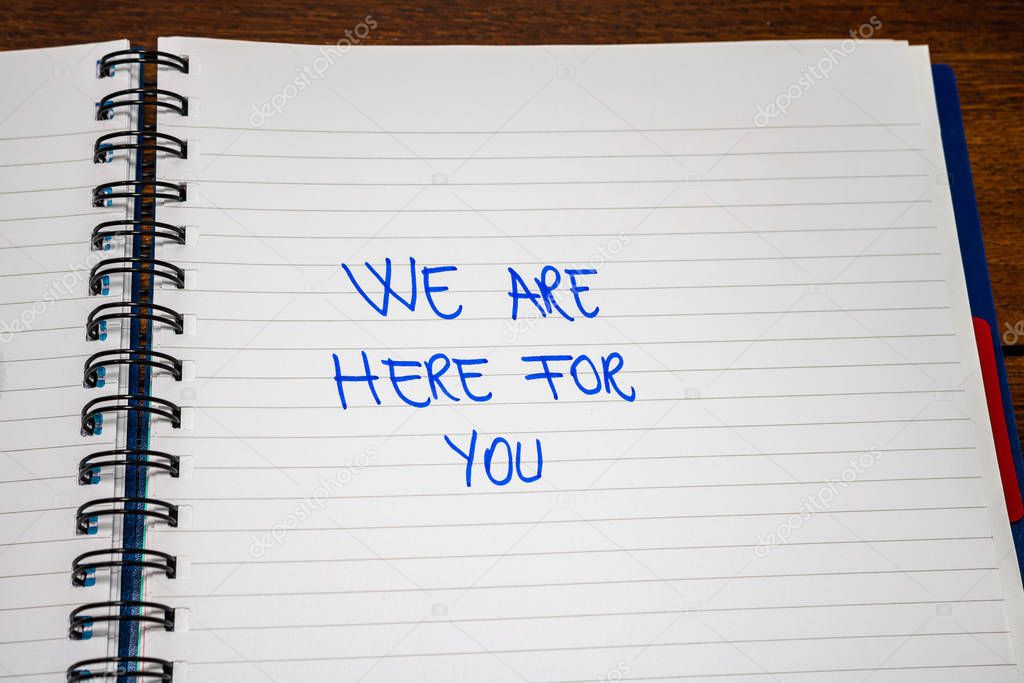 We are here for you handwriting  text on paper, on office agenda