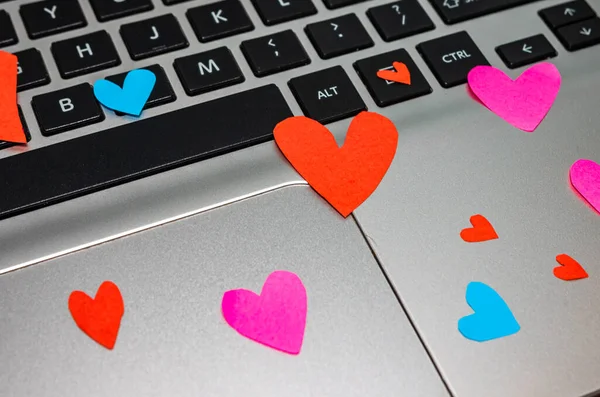 Heart shaped paper cut out on keyboard, love message and Valenti