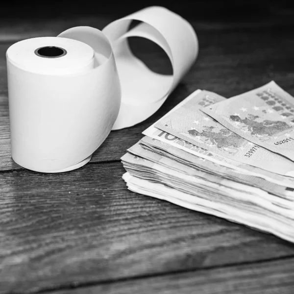 Roll of cash register tape and money isolated on table. Planning