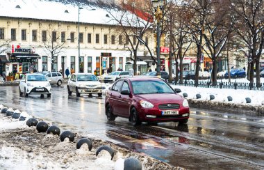Winter season and icy cars on the road in the morning rush hour 