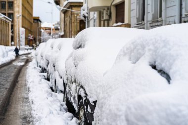 Cars covered with snow from the first snow fall of the year. Win