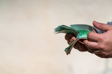 Man hand counting money for a bribe or tips. Holding EURO bankno