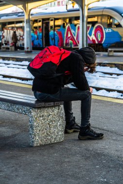 Travelers and commuters waiting for a train on the train platfor
